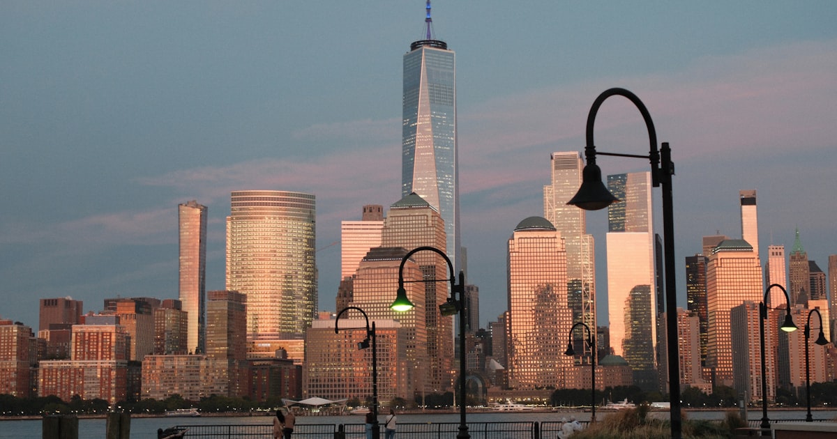New York City skyline at sunset with waterfront lights reflecting on the river, symbolizing the close of trading on April 1, 2026