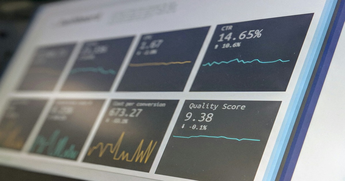 Financial data monitoring screens showing market charts and analytics during an active trading session