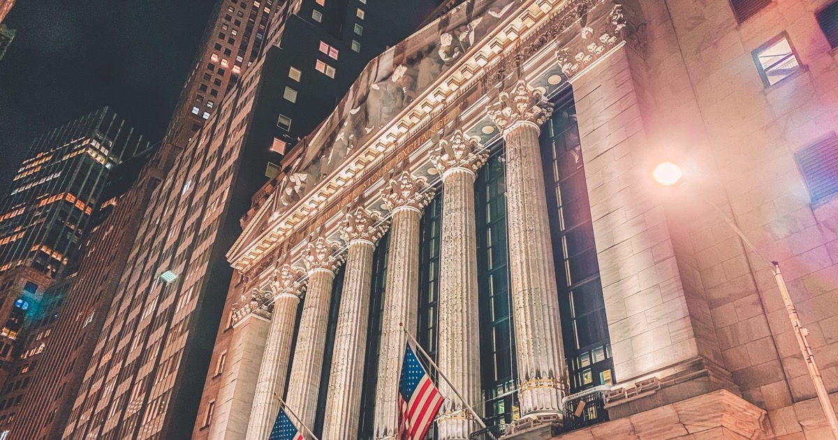 The New York Stock Exchange illuminated at night, matching the June 16, 2026 AlphaEdge end-of-day wrap on Dow strength, technology selling, lower oil and the Fed setup.