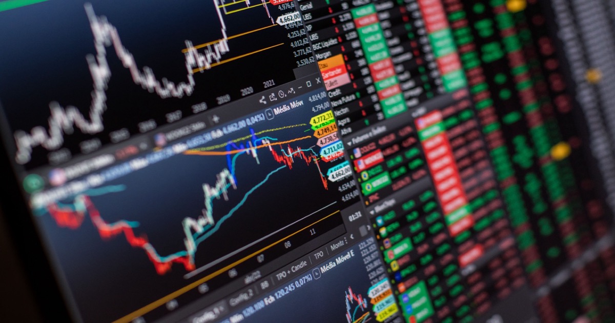 A close-up financial trading monitor with market charts and data, symbolizing the June 5, 2026 Nasdaq selloff and AI-chip pressure.