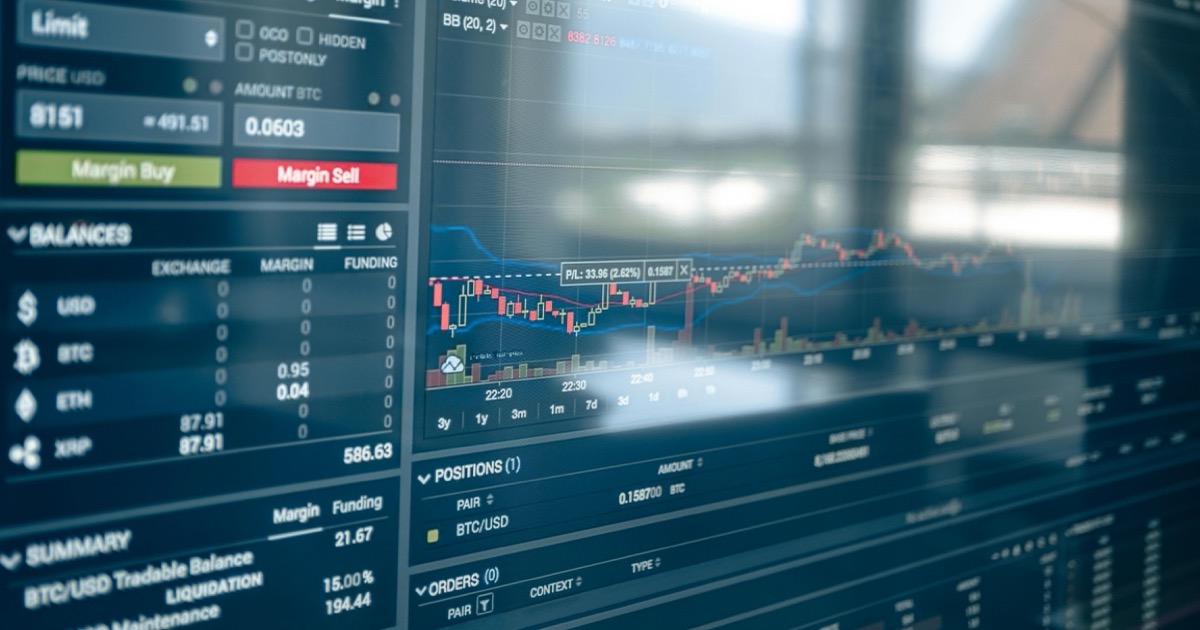 Close-up of digital trading screens showing market charts and financial data