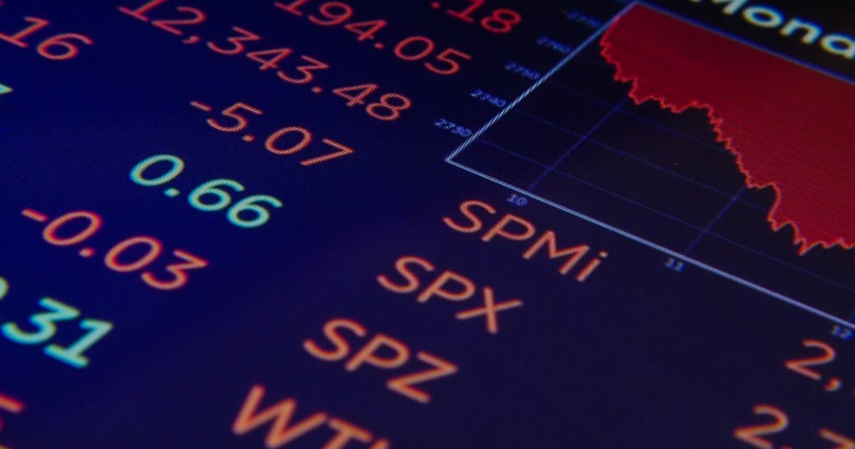 Close-up of a stock market screen showing SPX and SPMi tickers in red.