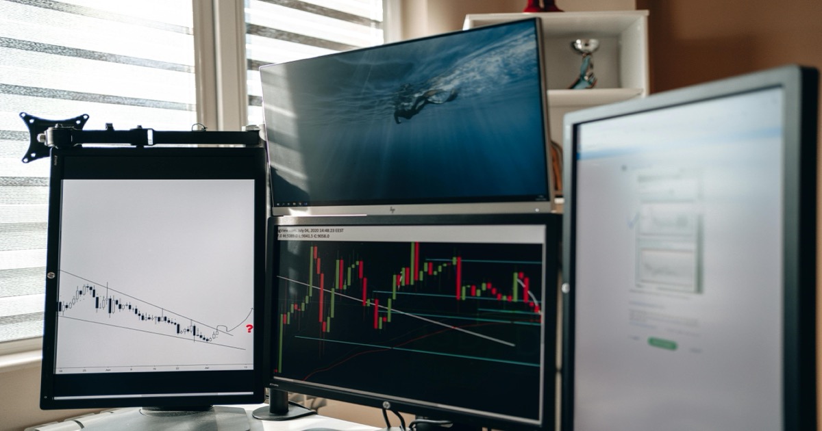 Multiple stock-market monitors show charts and data at a trading desk after the May 22 market close.