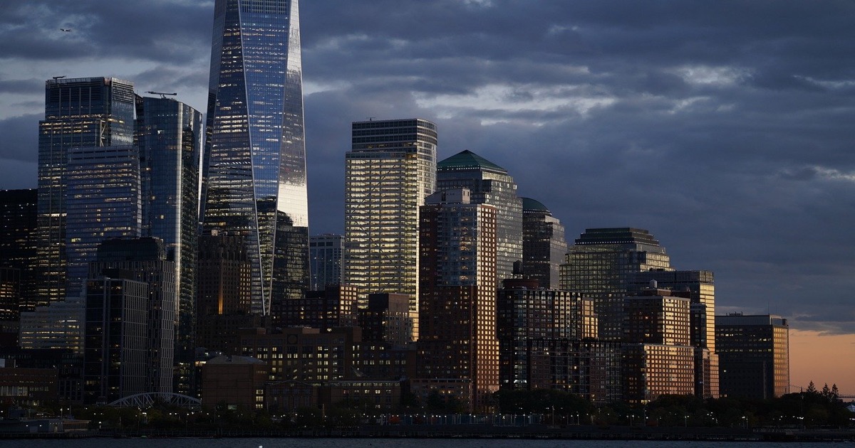 New York City financial district skyline at dawn with skyscrapers and morning light