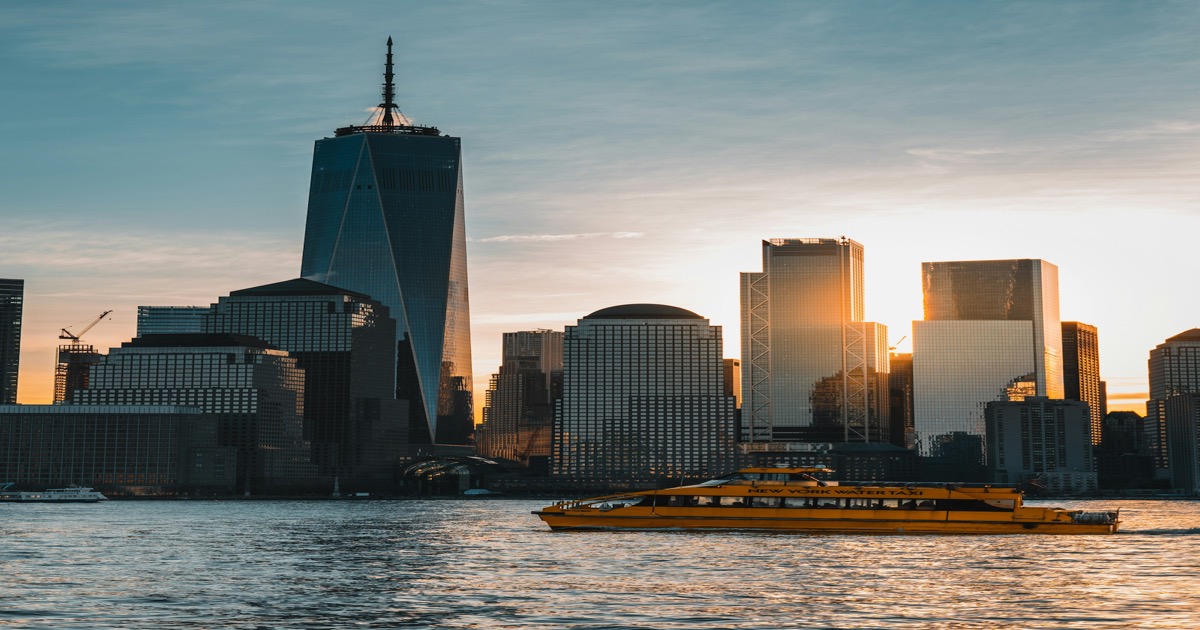 City skyline and financial district buildings rising into a bright morning sky