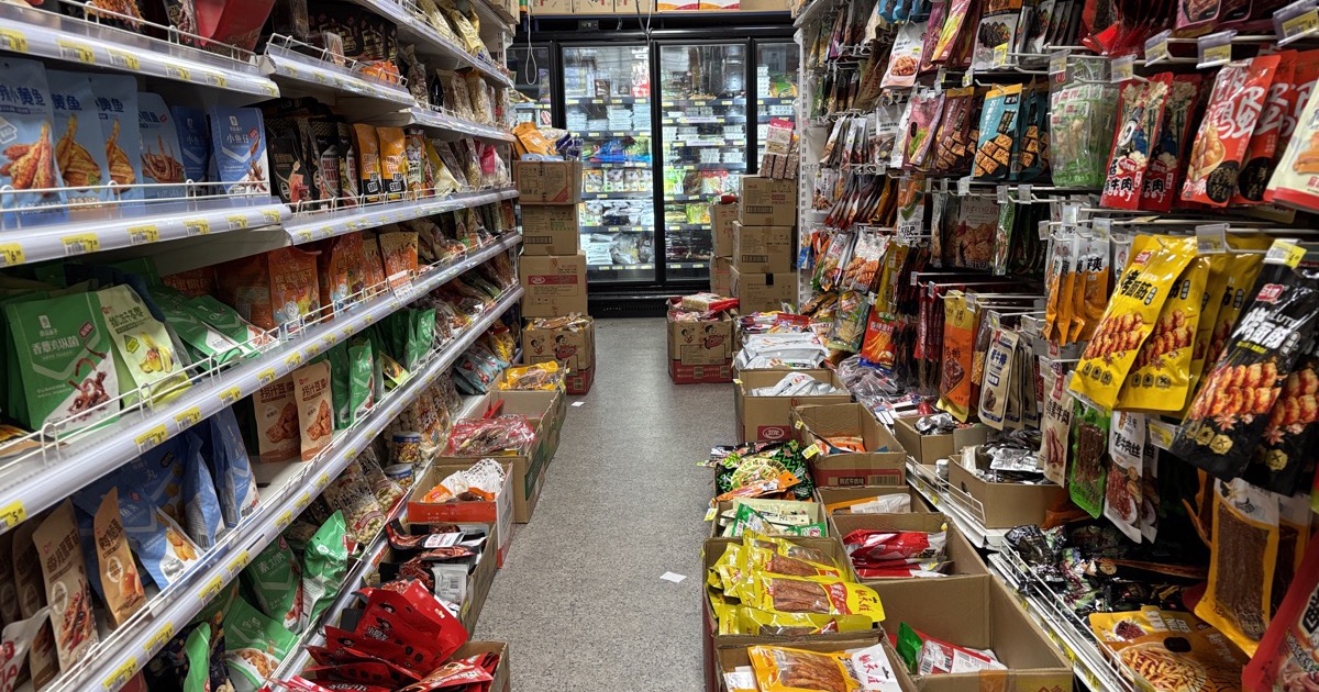 A grocery-store aisle lined with packaged goods, on the morning of August 11, 2026.