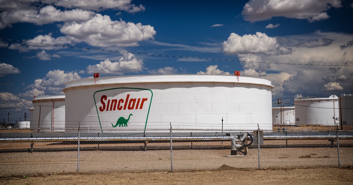 Crude oil storage tanks beneath a stormy sky before markets open on August 18, 2026.