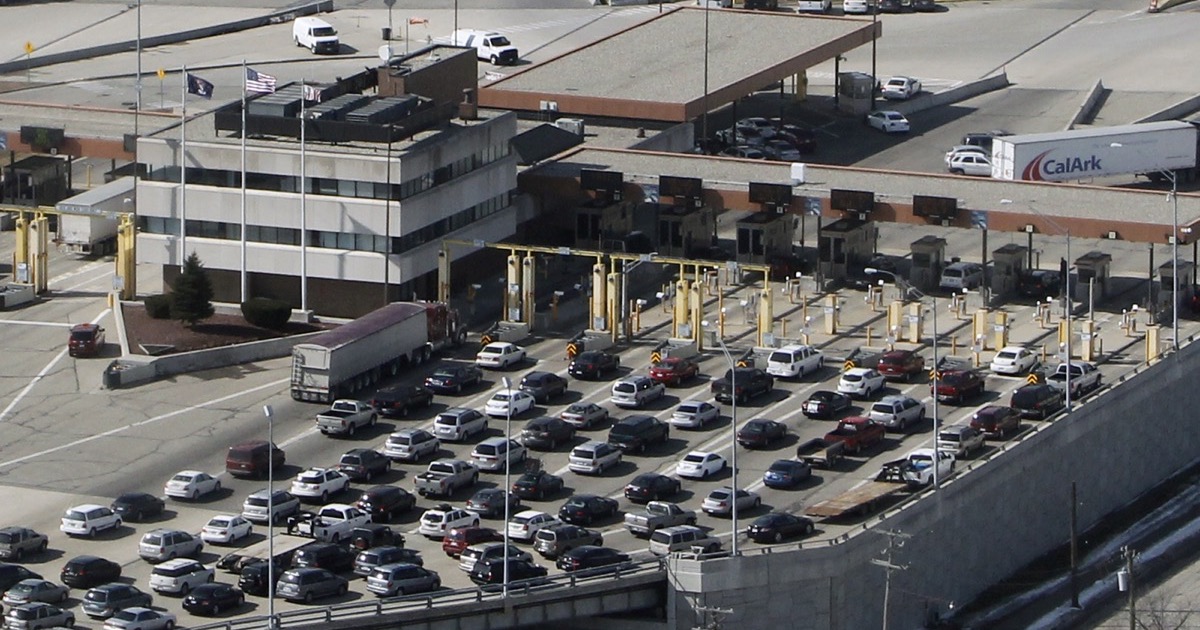 Vehicles and freight trucks queue at the Blue Water Bridge border crossing as U.S.-Canada trade risk returns on August 24, 2026.