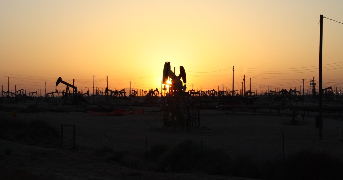 Oil pumpjacks silhouetted against a sunset, on the morning of August 3, 2026.