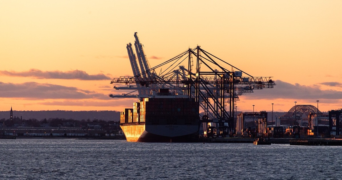A container ship at a New Jersey port terminal at sunset, on the morning of July 7, 2026.