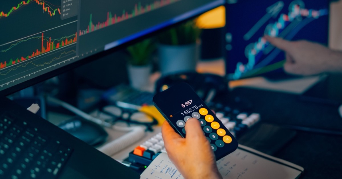A trading desk with market charts and a calculator, symbolizing the June 10, 2026 CPI morning update as futures slip and AI-chip stocks sell off.