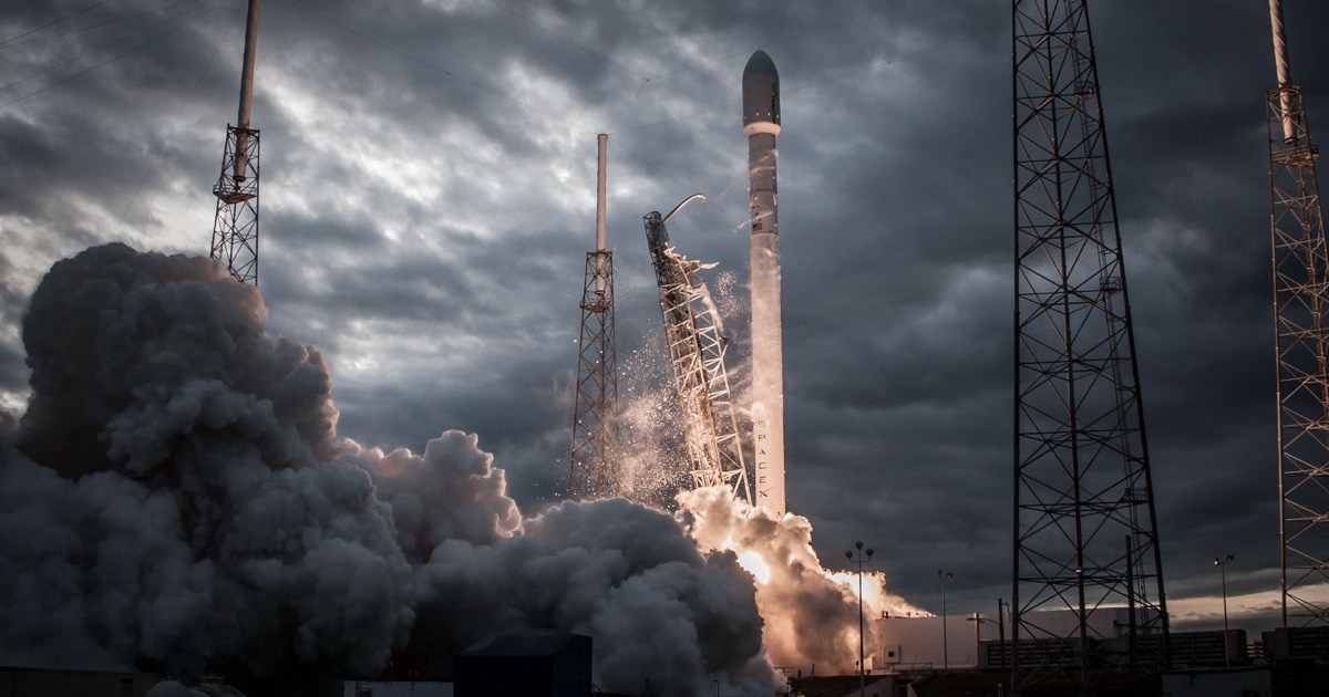 A SpaceX rocket launches through dark clouds, matching the June 12, 2026 morning update on the SpaceX IPO, futures and oil risk.