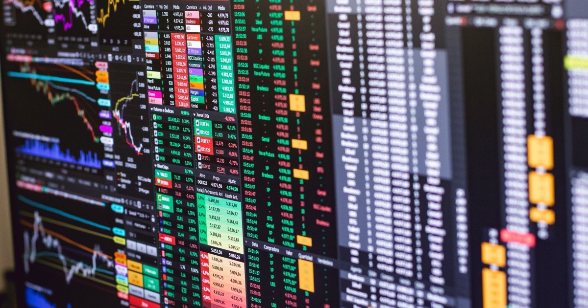 Detailed financial trading screens with colorful charts and market data, matching the June 16, 2026 AlphaEdge morning update on flat futures, SpaceX, Qualcomm, oil and BOJ policy.