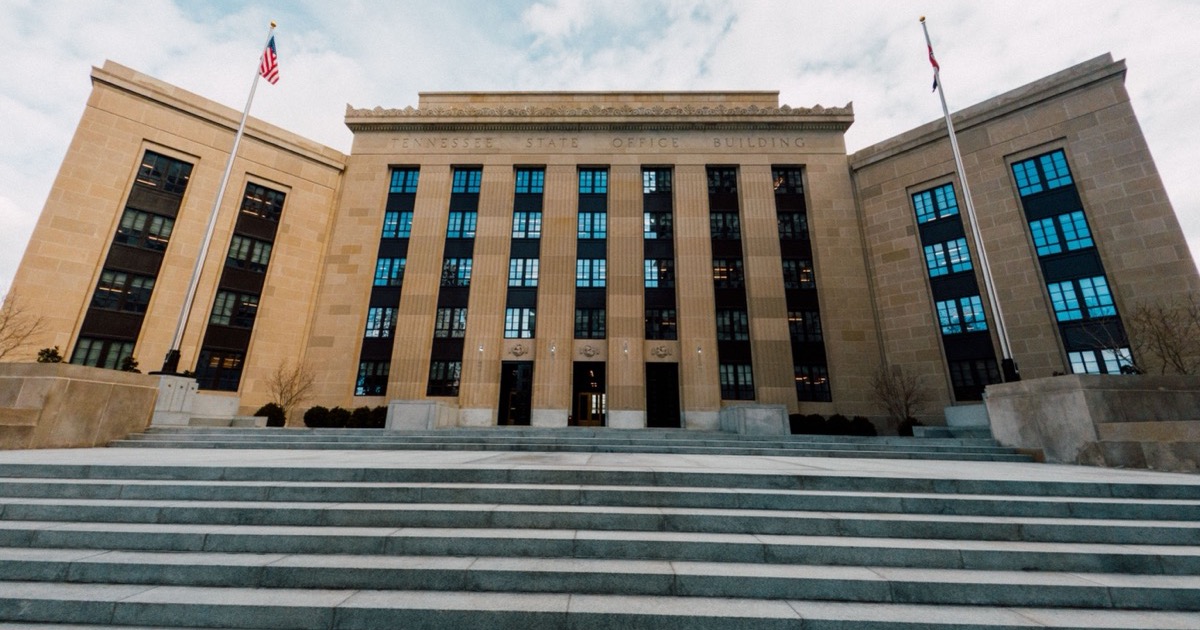 The Federal Reserve building facade with flags and stone steps, matching the June 17, 2026 AlphaEdge morning update on retail sales, Warsh's Fed decision, lower oil and higher futures.