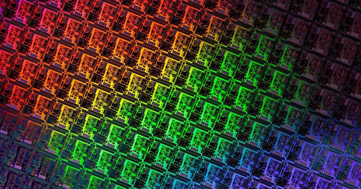 A silicon wafer patterned with rows of memory and logic dies in rainbow color gradients, emblematic of the semiconductor selloff on June 24, 2026.