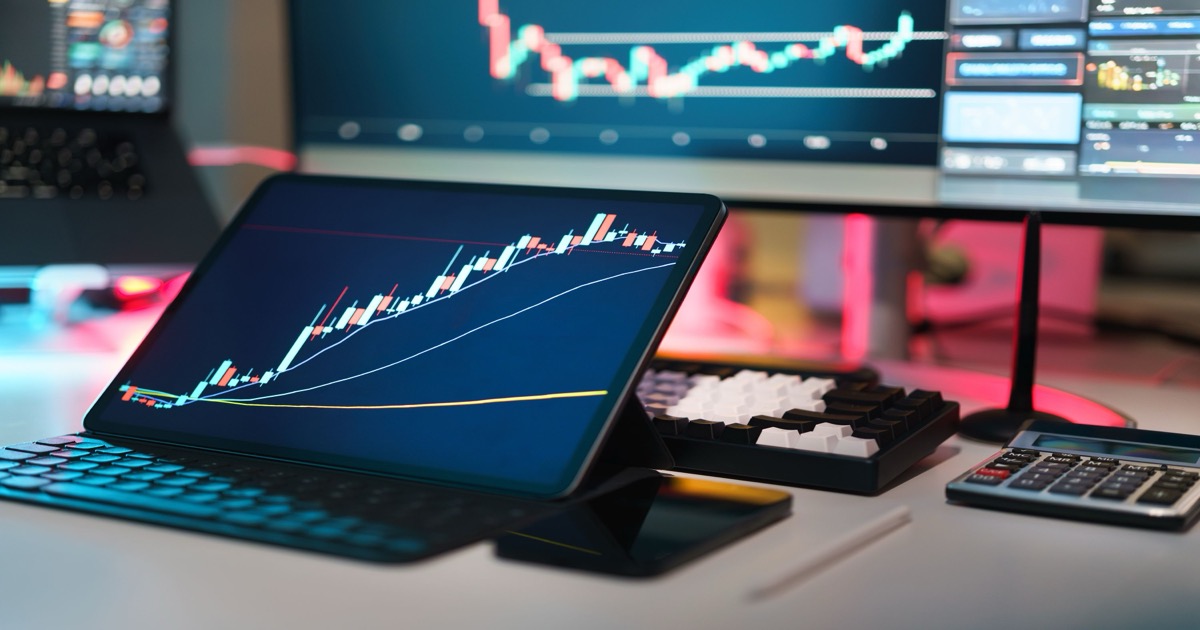 A modern trading desk with multiple screens showing market charts, symbolizing the June 4, 2026 premarket test for AI leadership and macro data.