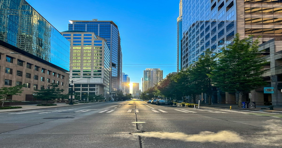 Sunlight streaming through downtown Seattle skyscrapers at sunrise representing a new trading day on March 31, 2026