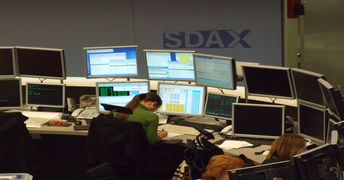 Trading desks and market monitors on a European exchange floor