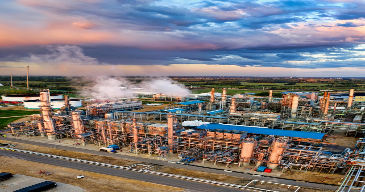 An aerial view of an oil refinery at sunrise represents the May 28 market focus on crude prices, Iran headlines and inflation risk.