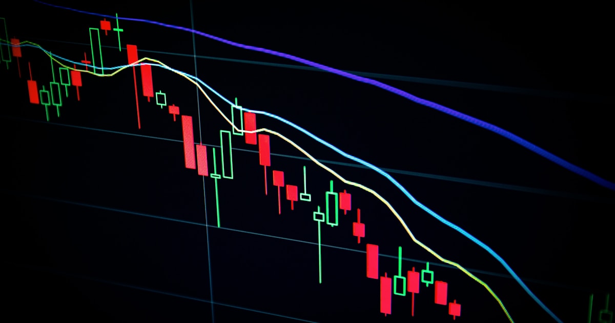 Financial market trading screens displaying stock price charts and green indicators