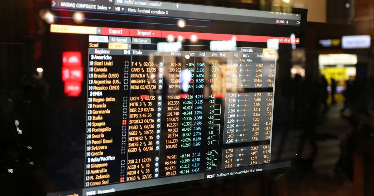 A financial market screen displays government bond yields and global market data.