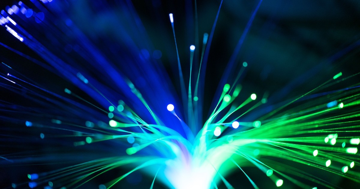 Blue and green fiber optic strands evoke the split between cloud software strength and cautious AI hardware trading.