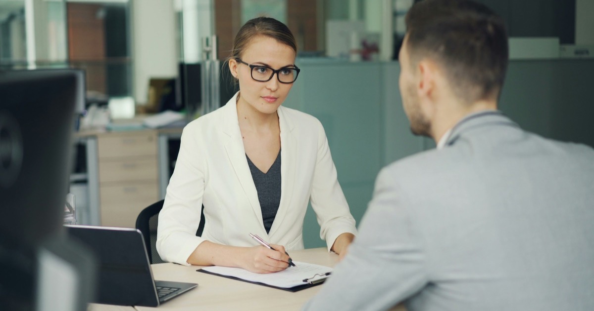 A recruiter interviews a job candidate at an office desk before the August employment report.