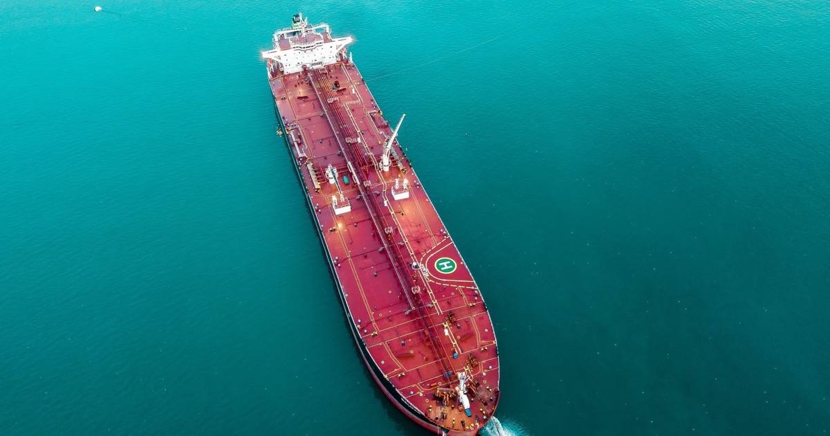 An oil tanker crosses open water as Brent crude breaks $100 and investors assess inflation and shipping risks.