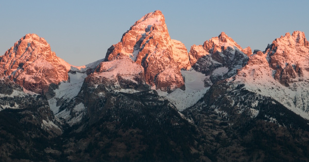 Morning light reaches Grand Teton before the Jackson Hole policy and earnings week
