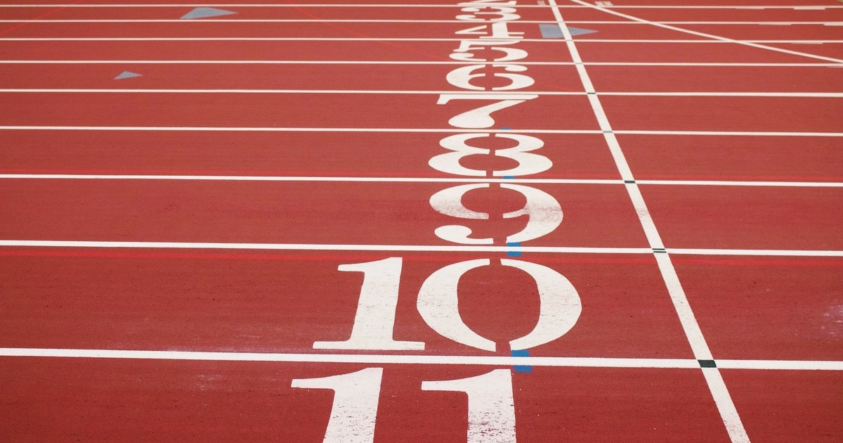 Numbered lanes on a red running track frame the market's jobs and policy test
