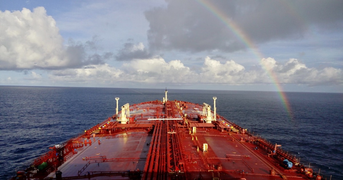 A large cargo ship sailing through open ocean waters
