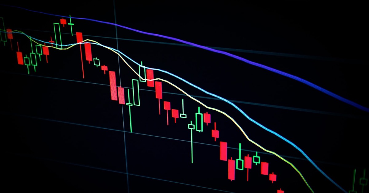 Abstract red and blue light streaks representing market volatility and directional momentum