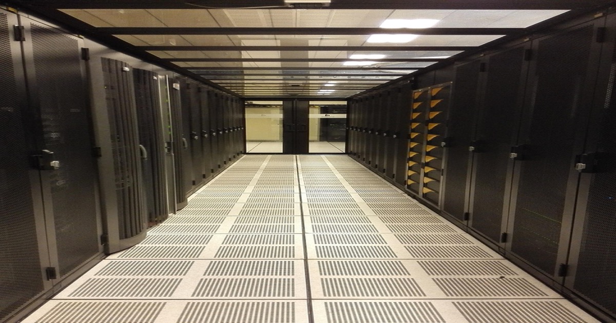 Data center server room with blue LED lighting representing the semiconductor supercycle